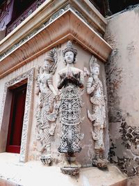 Low angle view of statue against building