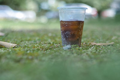 Close-up of drink on field