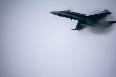 Low angle view of airplane flying against clear sky