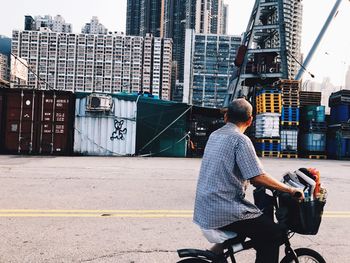 Man sitting on bicycle in city