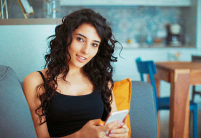 Portrait of beautiful young woman using mobile phone