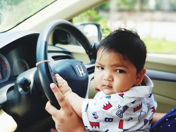 Portrait of cute boy in car