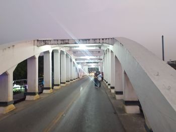 Rear view of people on bridge in city