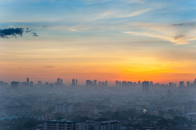 High angle view of cityscape against cloudy sky