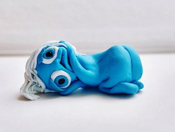 Close-up of blue toy over white background