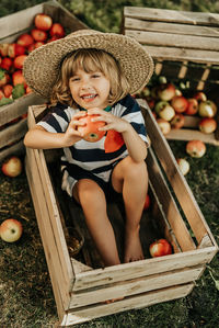 Portrait of cute baby boy sitting on grass