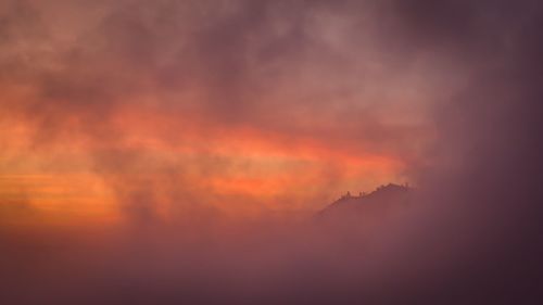 Low angle view of dramatic sky during sunset