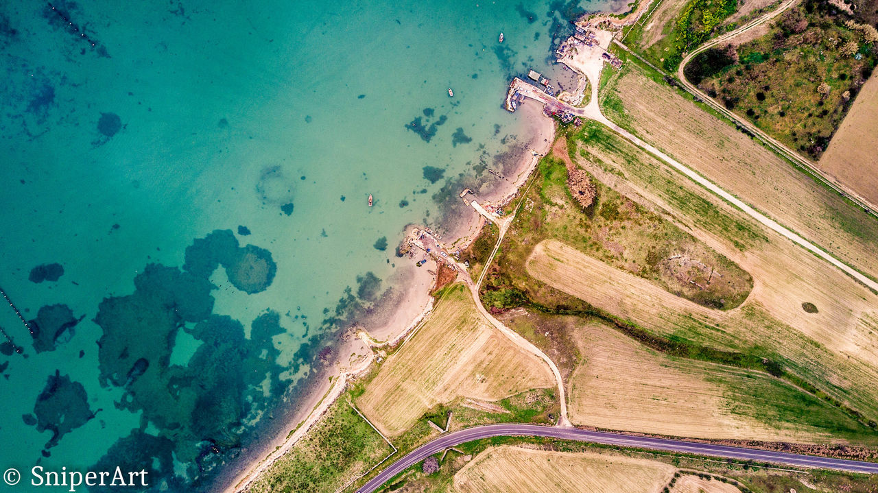 AERIAL VIEW OF MULTI COLORED UMBRELLAS ON SAND