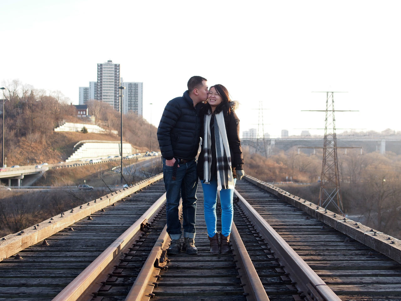 WOMAN STANDING ON RAILROAD TRACK