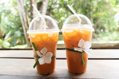 Close-up of drinks in disposable cups on table