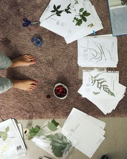 Low section of woman standing on paper