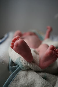 Close-up of baby hand on bed