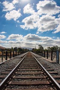 View of railway tracks against cloudy sky