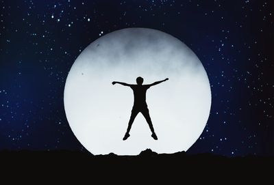 Low angle view of silhouette moon against sky at night