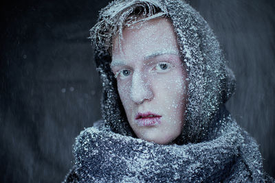 Close-up portrait of man with snow covered on face