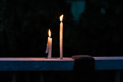 Close-up of lit candles in temple