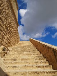 Low angle view of building against cloudy sky