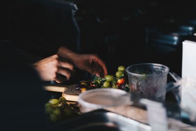 Midsection of man preparing food in kitchen