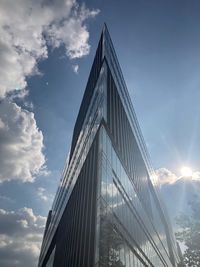 Low angle view of modern building against cloudy sky