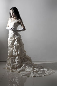 Bride standing against gray background