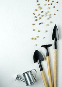 High angle view of tools on table against white background