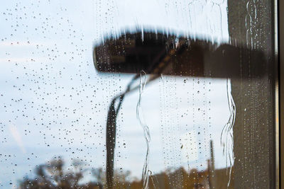 Close-up of wet glass window in rainy season