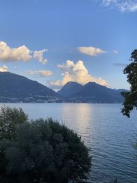 Scenic view of lake by mountains against sky