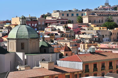 Houses in city against clear sky
