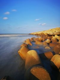 Close-up of rocks on beach against sky