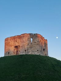 Low angle view of castle against clear blue sky