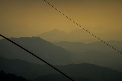 Low angle view of silhouette mountains against sky at sunset