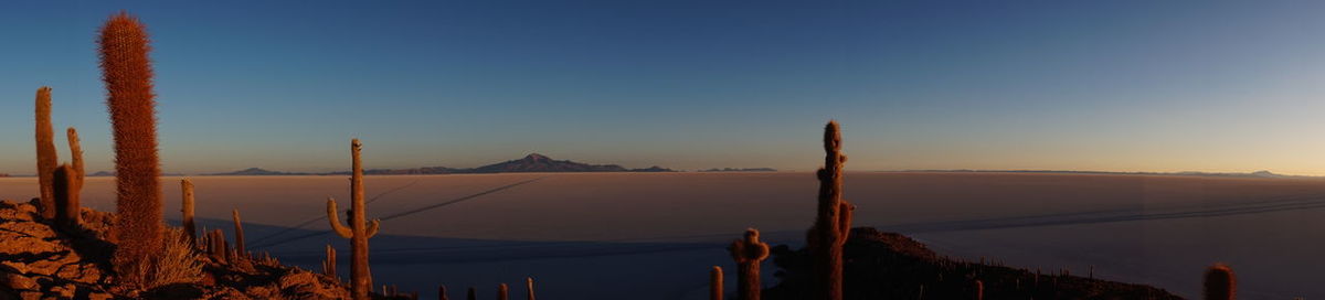 Scenic view of mountains against clear sky during sunset