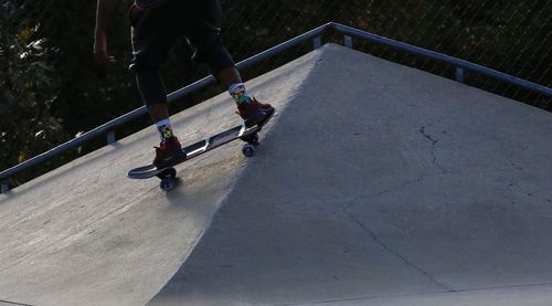 Low section of man skateboarding on skateboard