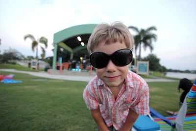 Boy wearing sunglasses on field