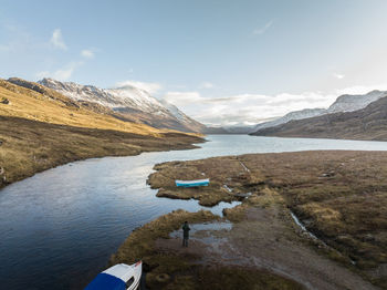 Scenic view of lake and mountains against sky