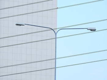 Low angle view of street light against modern building