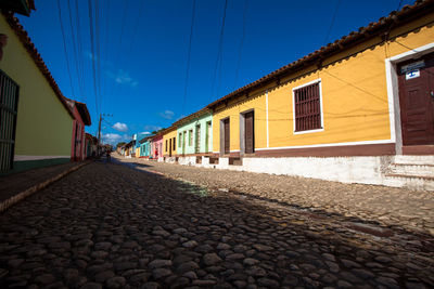 View of houses against blue sky