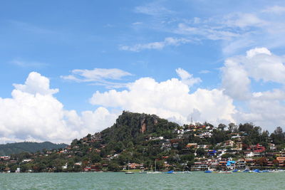 View of cityscape against cloudy sky