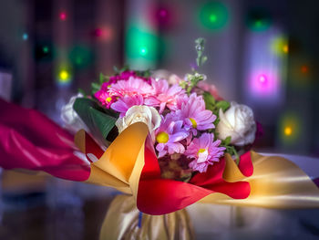 Close-up of hand holding flower bouquet