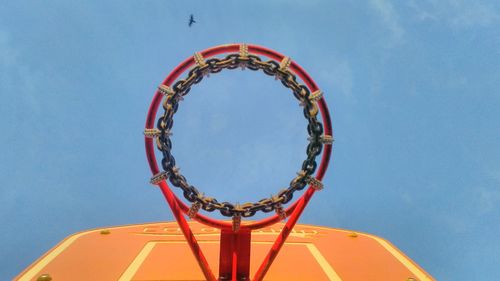 Low angle view of basketball hoop against blue sky