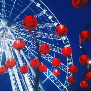 Low angle view of chinese lanterns hanging against ferris wheel