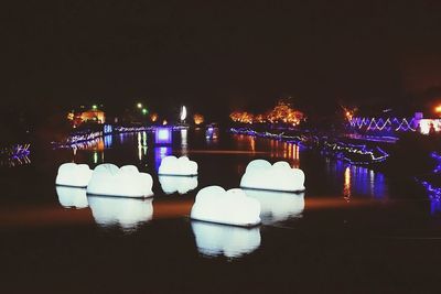 Reflection of illuminated lights in puddle