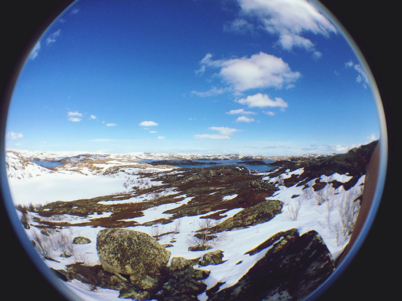 sky, blue, winter, snow, fish-eye lens, cloud - sky, scenics, window, landscape, transparent, cold temperature, nature, beauty in nature, tranquility, glass - material, tranquil scene, circle, aerial view, cloud, day