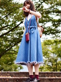 Low angle view of girl standing against trees