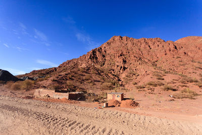 Scenic view of desert against blue sky