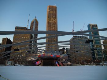 Modern buildings in city against clear sky