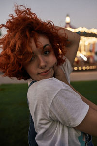 Portrait of young woman standing outdoors