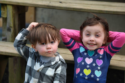 Portrait of siblings with hand in hair