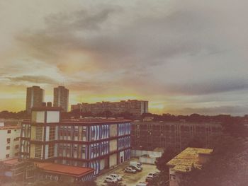 View of buildings against cloudy sky