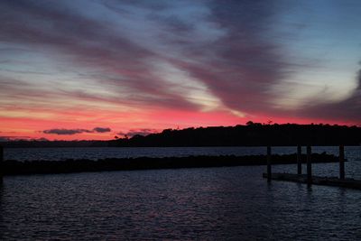 Scenic view of lake against orange sky